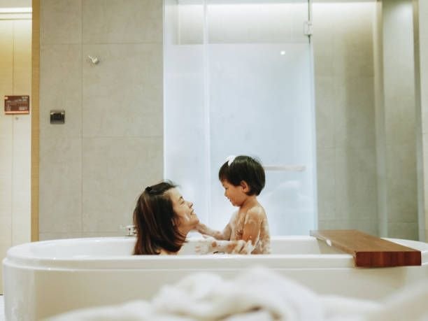 asian-mother-and-baby-son-having-fun-at-bath-time-together8379920922647240078.jpg