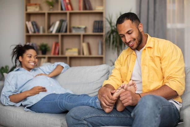loving-african-american-husband-massaging-pregnant-wifes-heels-at-home8573874677018905910.jpg